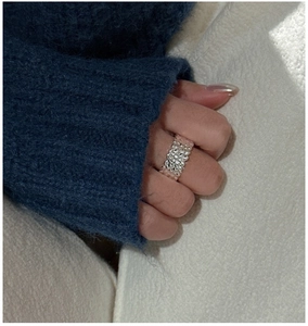 Macro detail of silver ring featuring textured lava finish on model hand