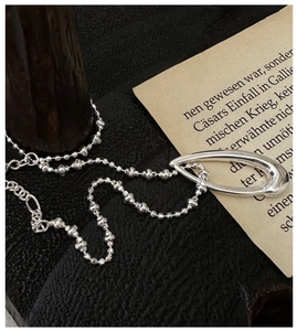 Detailed close-up of S925 sterling silver necklace with unique water drop pendant charm