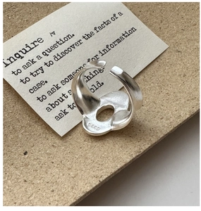 Detail view of S925 sterling silver open ring with S925 hallmark on minimalist inner band