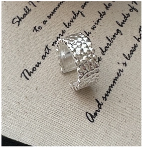 Detailed view of S925 sterling silver hammered texture ring on vintage burlap background