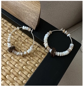 Detail of S925 silver beaded earrings featuring white shell beads and a vintage wood accent