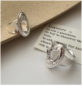 Detail of adjustable S925 silver ring featuring vintage sunburst oval cutout design