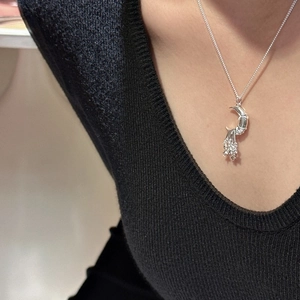 S925 sterling silver moon and stars tassel necklace worn on a black V-neck top