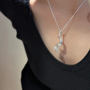 S925 sterling silver moon and star pendant necklace worn on a model neckline