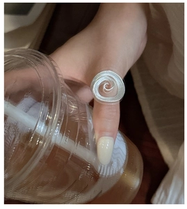 Close-up of minimalist S925 sterling silver spiral ring with matte brushed finish