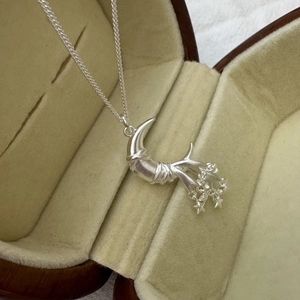 S925 sterling silver moon and star pendant necklace on beige velvet jewelry box