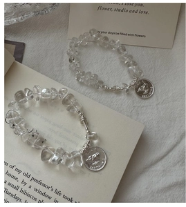Detail shot of S925 silver beaded bracelet with clear crystals and a bird pendant charm