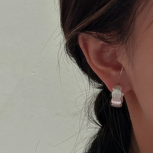 Minimalist S925 sterling silver floral huggie earrings with vintage brushed texture on model