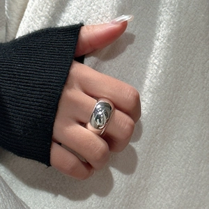 Polished S925 sterling silver dome ring with a sleek minimalist aesthetic on a female hand