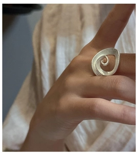 Detail view of S925 sterling silver spiral ring featuring a matte brushed finish