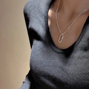 Minimalist S925 sterling silver double oval link necklace on black sweater worn by model