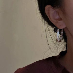 Handmade beaded hoop earrings featuring white and brown beads in a retro vintage style