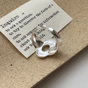 Adjustable S925 sterling silver ring featuring an irregular hollow geometric design