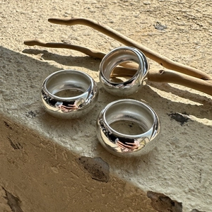 Three minimalist S925 sterling silver dome rings with high-polish finish on stone