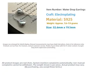 Detailed view of large S925 sterling silver drop earrings with smooth polished finish