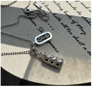 Close-up of S925 silver necklace featuring retro Vajra and ancient coin pendants