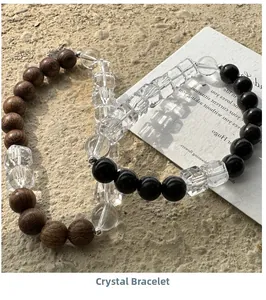 Close-up of minimalist crystal bead bracelets with brown wood and black agate details