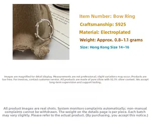 Macro detail of S925 sterling silver bow knot ring on rustic paper background