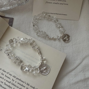 S925 silver beaded bracelets with clear crystals and vintage bird pendants on linen cloth