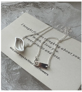 Close-up of S925 sterling silver necklace with hollow leaf pendant and polished metal tag