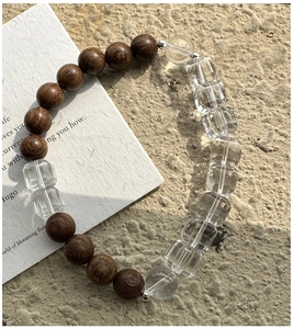 Detail of wooden beads and faceted crystals on an elastic S925 silver bracelet