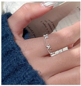 Close-up of S925 silver beaded bow ring with sparkling zircon stones on a finger