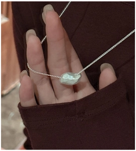 Detailed shot of an irregular polyhedron S925 sterling silver pendant on a fine link chain