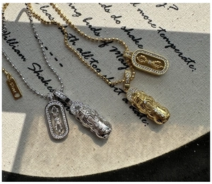 Macro view of S925 silver Vajra and Pixiu pendants with pave-set diamonds