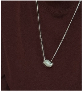Macro shot of S925 sterling silver necklace featuring a geometric faceted pendant