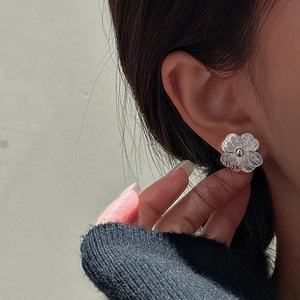 S925 sterling silver floral stud earrings with vintage texture on female model