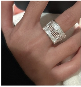 Close-up of wide S925 sterling silver ring with rock texture and square grid design
