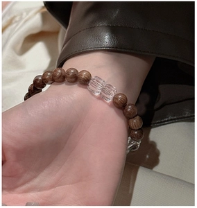 Detail of S925 silver bracelet featuring dark wood beads and clear crystal cubes on wrist