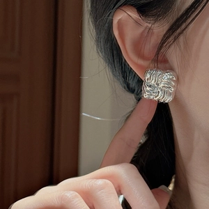 S925 sterling silver square earrings with woven texture worn by a female model