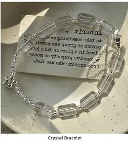 Detail of square crystal beads and silver charms on an S925 sterling silver bracelet
