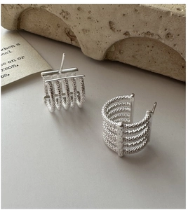 Detailed macro view of S925 sterling silver multi-layer earrings with vintage bead texture