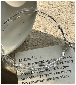 Macro detail of square clear crystal beads and silver spacers on a S925 silver bracelet