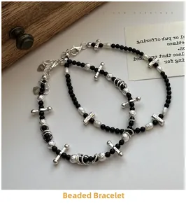 Macro view of S925 sterling silver beaded bracelet with cross and heart tag detail