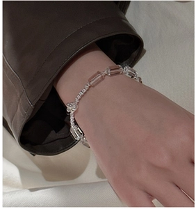 Detail of S925 sterling silver beaded bracelet with pink crystal and flower charm