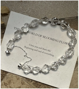 Close-up of faceted crystal beads and silver-tone metal spacers on a S925 silver bracelet