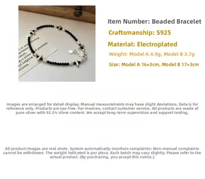 Detail view of S925 silver beaded bracelet with black beads and a heart charm