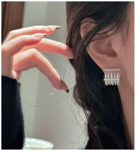 Macro shot of S925 sterling silver geometric earring with textured vertical lines design