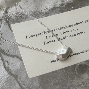 Minimalist S925 sterling silver necklace with geometric rock pendant on artistic card