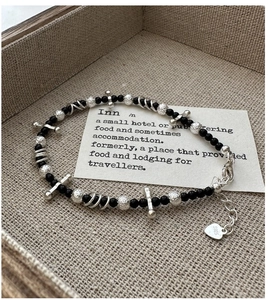 Detail of S925 sterling silver beaded bracelet with black beads and textured silver spheres