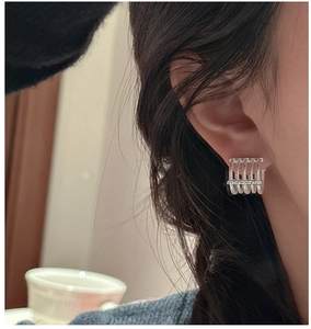Macro shot of S925 sterling silver hoop earrings with five rows of sparkling cubic zirconia