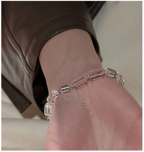 Detail of S925 sterling silver bracelet with square white crystals and fine metal chain