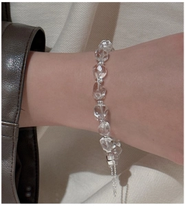 Macro shot of transparent faceted crystal beads and silver spacers on a sleek S925 bracelet