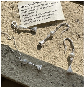 Macro detail of S925 sterling silver beaded necklace with striped pearl pendant