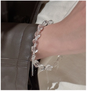 Macro view of transparent faceted crystal beads and silver metal extension chain