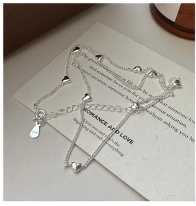 Macro shot of S925 sterling silver heart necklace with hallmark and spring clasp detail