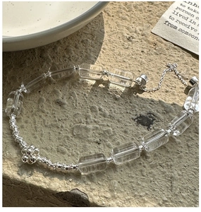 Close-up of S925 silver bracelet with square white crystals and floral detail